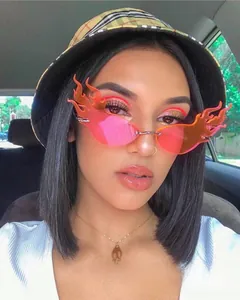 Close-up of pink-orange gradient flame-shaped rimless sunglasses for Y2K fashion style