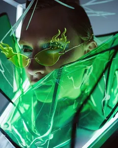 Macro detail of futuristic flame-shaped green sunglasses with a cyberpunk aesthetic