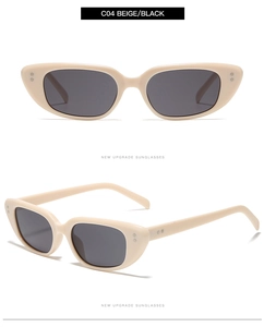 Detail view of beige cat-eye sunglasses featuring dual metal rivets and black lenses