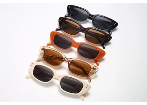 Close-up of retro narrow frame sunglasses in multiple colors showing model details