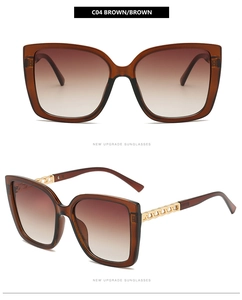 Dettaglio occhiali da sole cat-eye vintage con aste a catena in metallo dorato