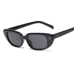 Retro black cat-eye sunglasses with metal rivet accents shown at a 45-degree angle