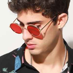Retro round sunglasses featuring red transparent lenses and slim gold metal frame on model