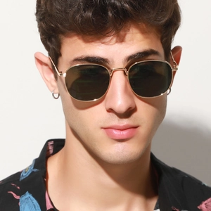 Detail of vintage oval sunglasses with slim gold metal frame and dark green lenses