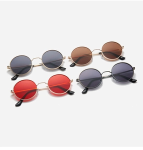 Macro display of retro round metal sunglasses in various lens colors for men and women