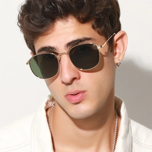 Close-up of vintage square metal sunglasses with gold frames on a male model
