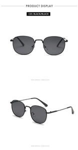 Detail view of vintage small metal frame sunglasses with black lenses and clear nose pads