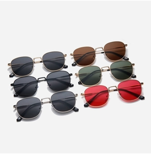 Multiple vintage square metal sunglasses in various lens colors neatly arranged