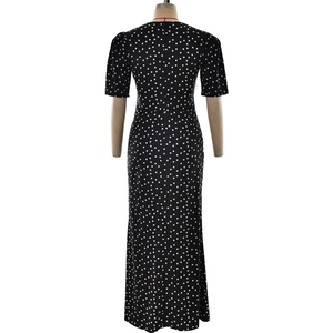 Detail of white polka dot print on black dress with back hidden zipper and slim waist cut