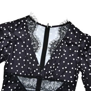 Close-up of deep V-neck with eyelash lace trim and polka dot satin fabric details