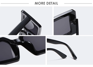 Detail view of stylish square sunglasses with sturdy hinges and high-gloss black frames
