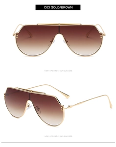 Détail de lunettes de soleil en métal doré avec verres dégradés bruns et rivets