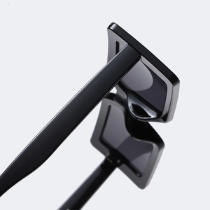 Chic black small square sunglasses with wide temples and high gloss finish on white background