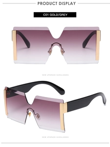 Detail view of gold metal hardware and grey gradient lenses on rimless square sunglasses
