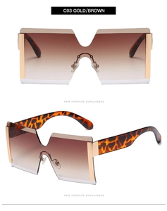 Detail of gold oversized rimless sunglasses with gradient brown lenses and leopard arms