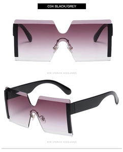 Detail view of oversized rimless sunglasses featuring purple gradient lenses and black frames