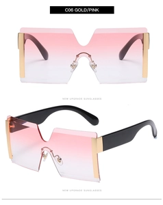 Close-up of rimless gradient pink sunglasses with gold metal side details and black arms