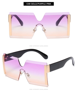 Detail view of gold frame oversized rimless sunglasses with purple pink gradient lenses