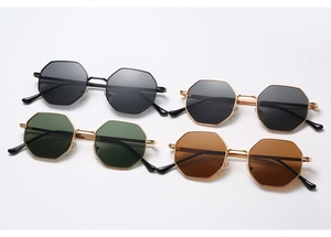 Detail view of retro octagonal metal sunglasses in black, gold, green, and brown lenses