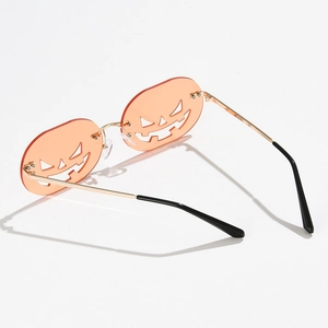 Funny pumpkin-shaped sunglasses with orange lenses and golden frame for Halloween parties