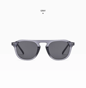 Detailed macro view of gray flat top pilot sunglasses with metallic stud hinges