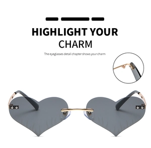 Detailed close-up of heart flame sunglasses with feather pattern and metal hinge