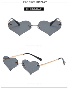 Detail view of heart-shaped rimless sunglasses with flame-textured dark grey lenses
