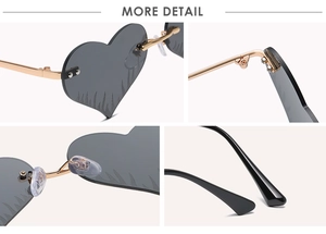 Detail view of heart-shaped flame sunglasses showing gold metal hinges and nose pads