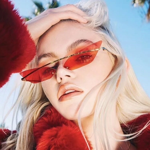 Fashionable red cat-eye sunglasses with gold metal frame and translucent lenses for women