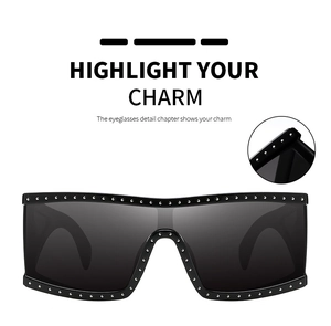 Close-up of oversized square sunglasses featuring silver stud embellishments and wide lens