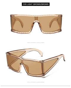 Front and side view of brown oversized shield sunglasses with silver stud details