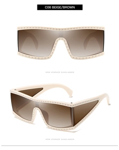 Detail of beige oversized shield sunglasses with metal studs and brown gradient lenses