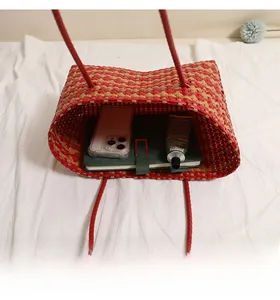 Top view of woven tote bag interior showing large capacity for phone and notebooks