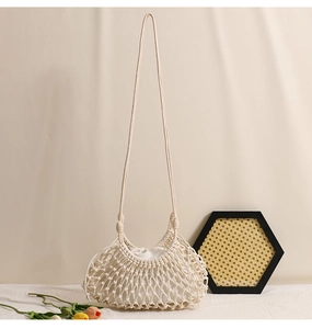Detail view of the intricate crochet weave and cotton lining on this cream beach bag