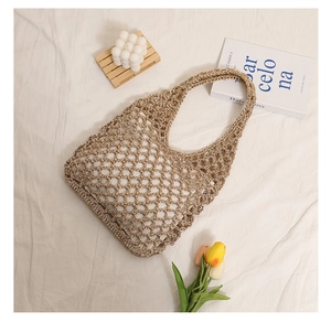 Detailed macro view of hollow out woven straw bag featuring rustic mesh texture