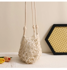 Detail view of handmade hollow mesh woven bag with white drawstring inner lining