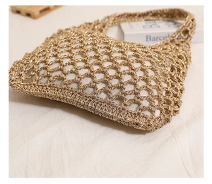 Detailed macro view of champagne gold woven texture and hollow mesh on beach shoulder bag