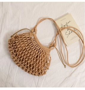 Detail of hand-woven hollow mesh shoulder bag with a cotton drawstring inner pouch