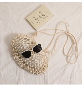 Detail of crochet weave pattern with inner pouch and stylish summer accessories