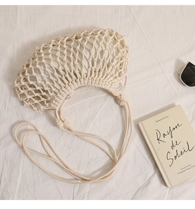 Detailed view of beige cotton rope woven bag with hollow mesh pattern and white lining