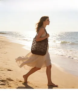 Close-up of a brown woven hollow beach bag with a stylish lattice rope pattern for women