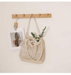 Detail of hand-woven cream tote bag with hollow pattern and drawstring inner pouch