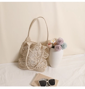 Detail view of beige hollow-out woven tote bag for beach vacations and shopping
