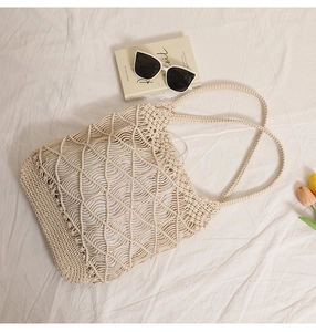 Detailed wave pattern hollow woven beach tote bag with sunglasses and tulip props
