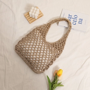 Handwoven khaki straw shoulder bag with hollow mesh design for summer beach vacation