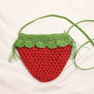 Handmade red strawberry crochet crossbody bag with green leaf detail for beach vacations