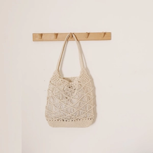 Chic cream woven tote bag with hollow diamond pattern for beach holidays and vacations