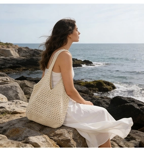 Detail of hollow-out cotton crochet texture on a beige beach tote bag at seaside
