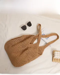 Detail of hollow woven cotton mesh pattern on a brown oversized beach tote bag