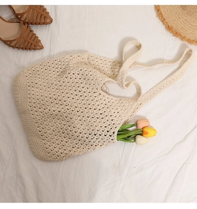 Detail of hollow woven cotton tote bag with soft texture for summer beach vacation